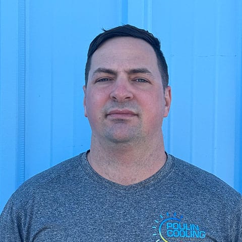 Portrait of a Poulin Cooling team member in front of a blue wall.