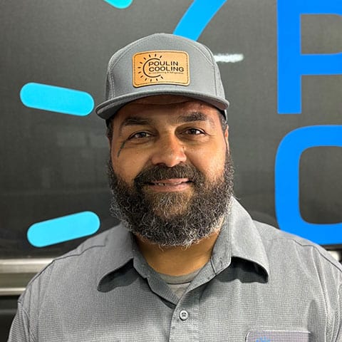 Poulin Cooling team member in uniform with company cap, representing professional service.