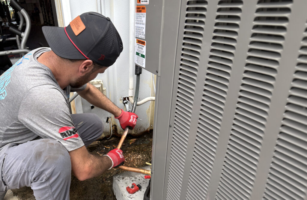 Technician repairing outdoor air conditioning unit in Clearwater.