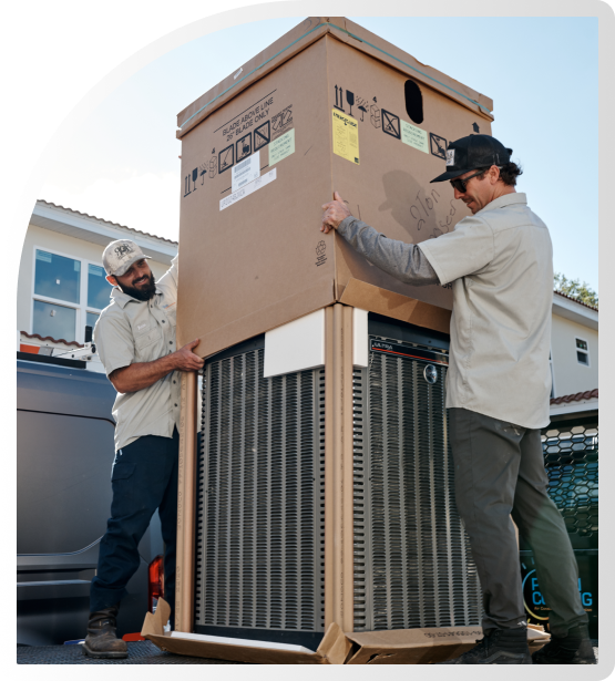 2 Workers unboxing an AC Unit